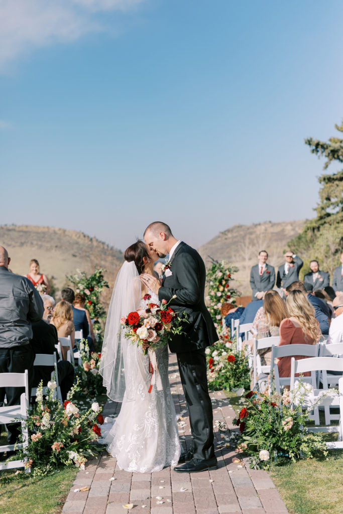 Colorado Bride and Groom kissing Right after they finish their wedding ceremony.